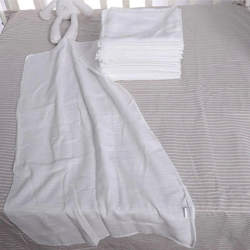 Cotton Gauze Cloth Diaper Inserts 10-Pack displayed with soft white fabric and a plush toy on a crib sheet.